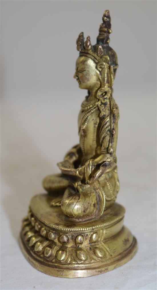 A small Tibetan gilt bronze seated figure of Amitayus, 18th/19th century, height 11cm